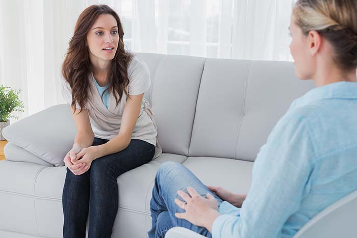 woman on couch talking to therapist