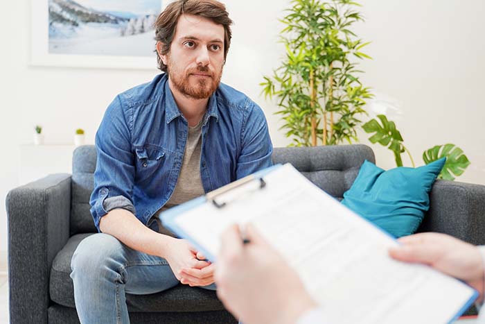 man on couch talking to therapist
