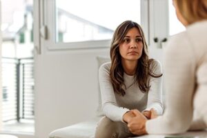 woman looks at therapist while discussing a panic disorder treatment program 