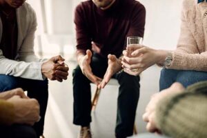 person talks with their hands in a group therapy program