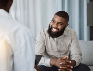 man with beard talks with therapist about united healthcare insurance coverage