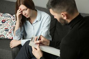 a person looks concerned as they talk to a therapist about schizoaffective disorder treatment 