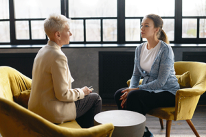 a client talks to a therapist during process addiction treatment